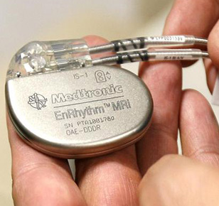 A doctor displays a pacemaker.